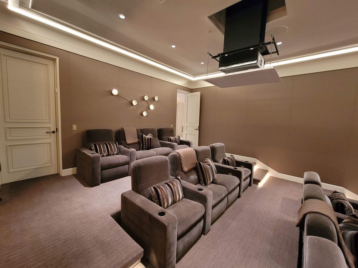 Home theater with leather recliners and a ceiling-mounted projector