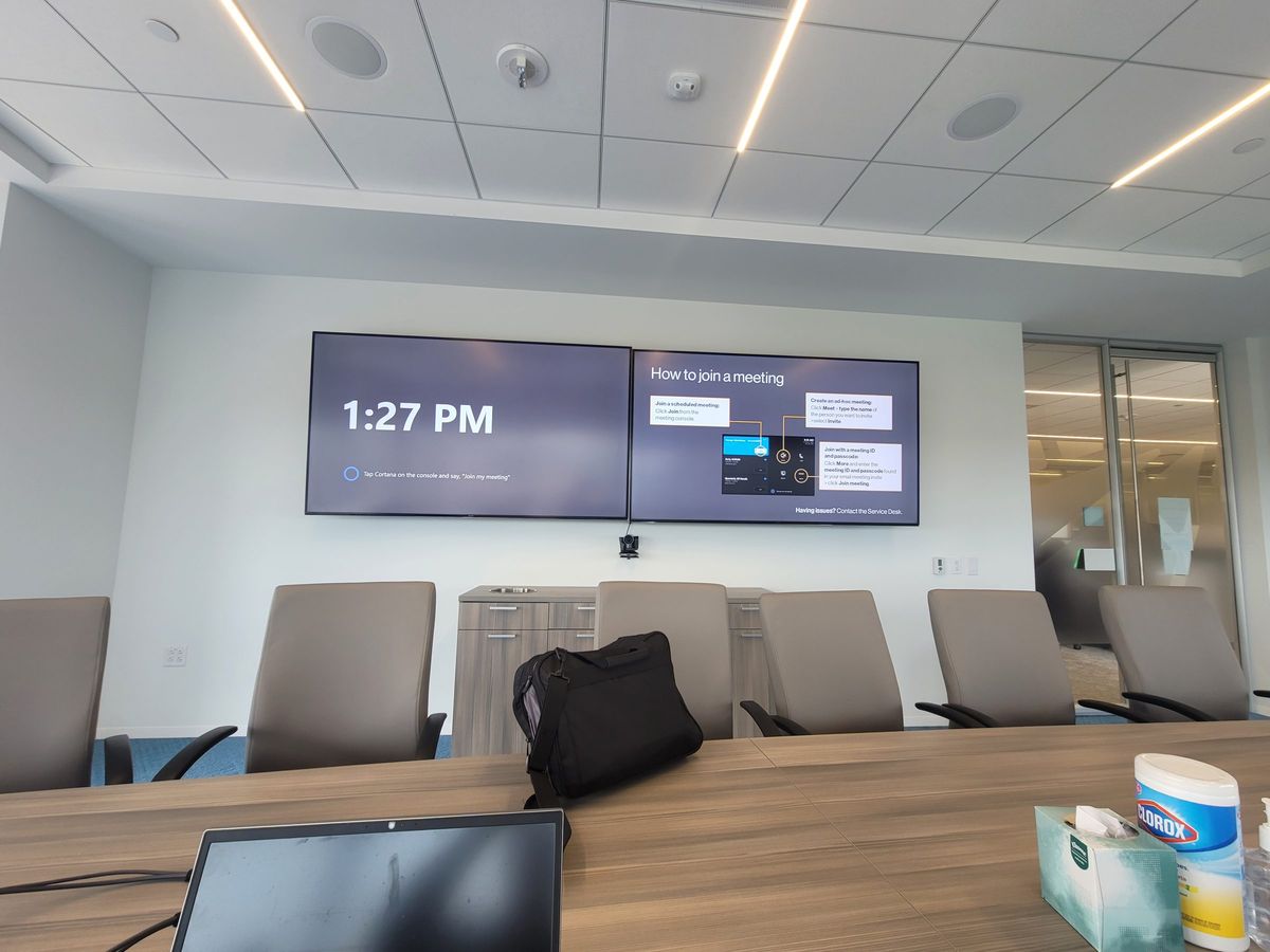 Conference room with dual displays and ceiling speakers