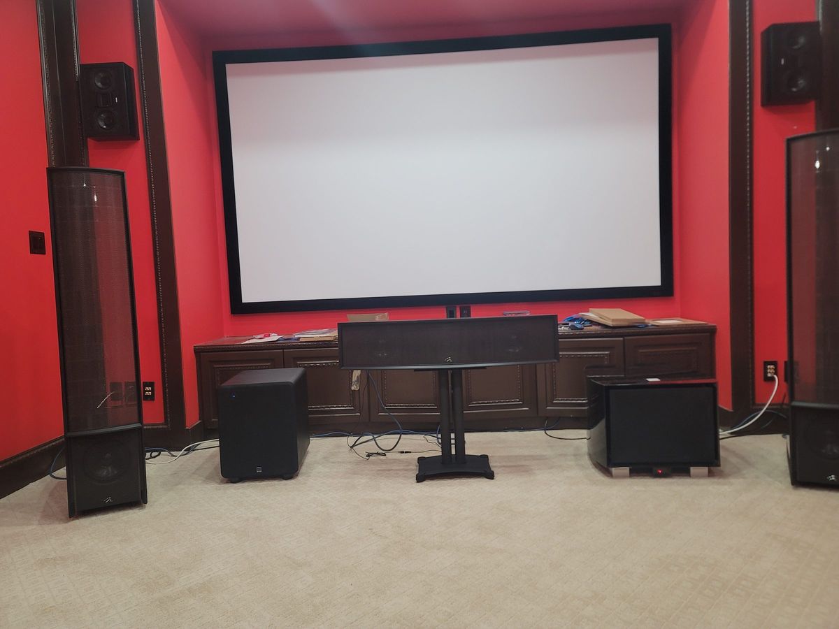 Red home theater with projection screen and surround speakers