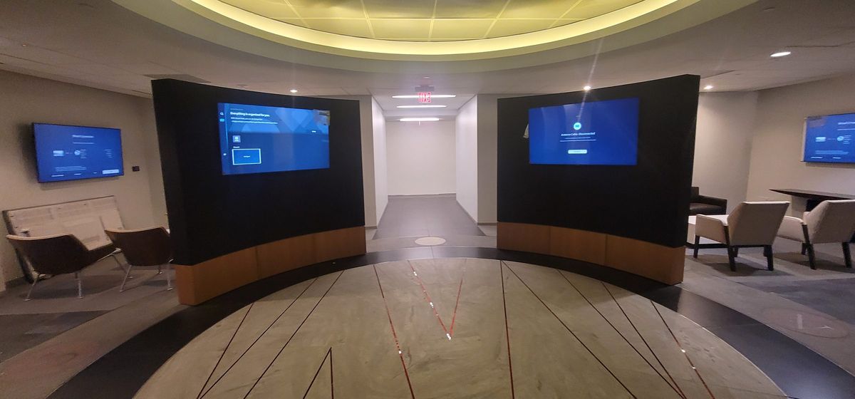 Curved wall with integrated displays in a commercial space