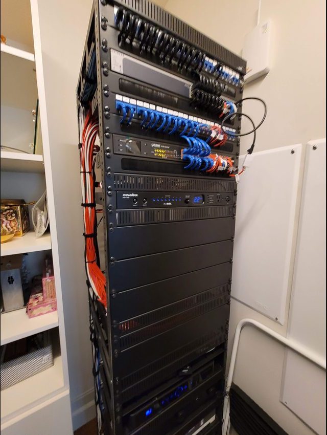 Smart-home equipment rack being serviced in a Houston closet