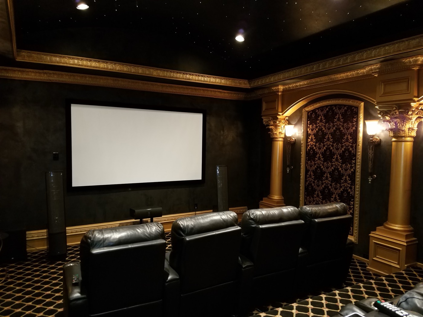 Dedicated Bellaire home theater with fiber-optic star ceiling, fixed projection screen, tower speakers and leather recliners