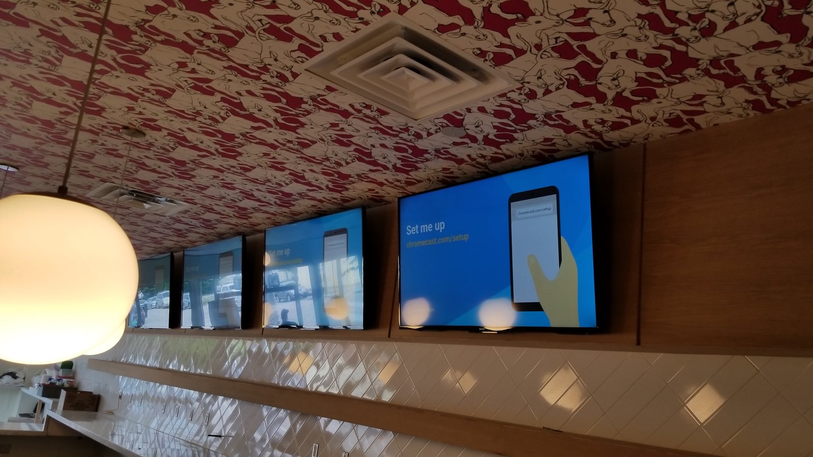 Row of commercial displays mounted above a bar counter