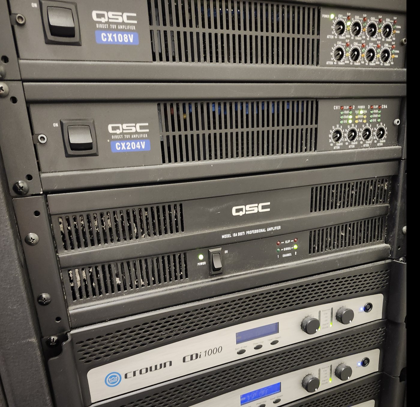 Rack of QSC and Crown commercial amplifiers on an Obsidian AV project in downtown Houston