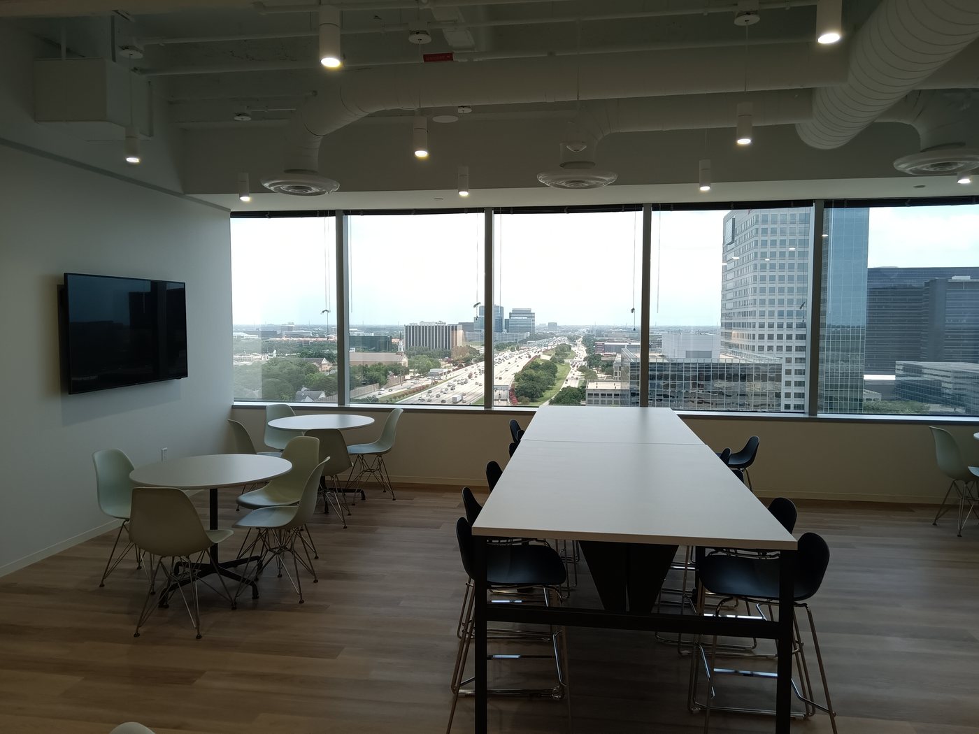 Office meeting space with a wall-mounted display near Greenway Plaza, Houston, an Obsidian AV project