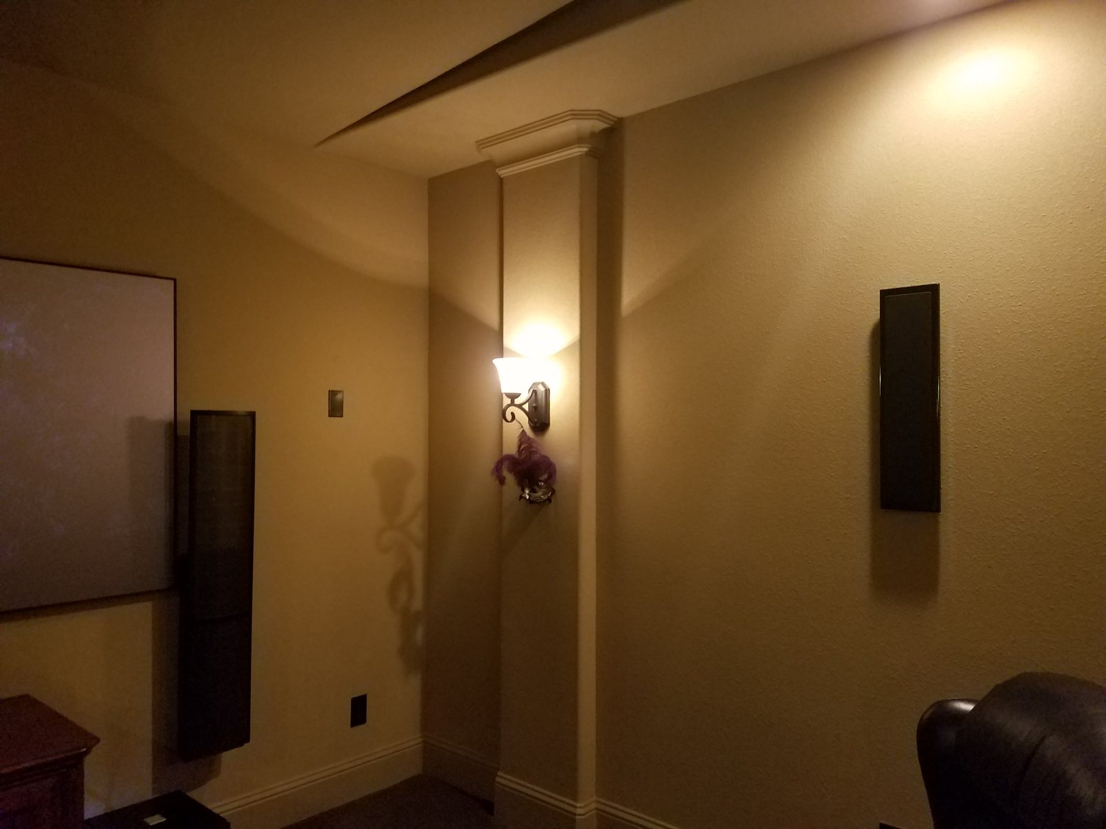 Home theater with wall sconces and in-wall speakers
