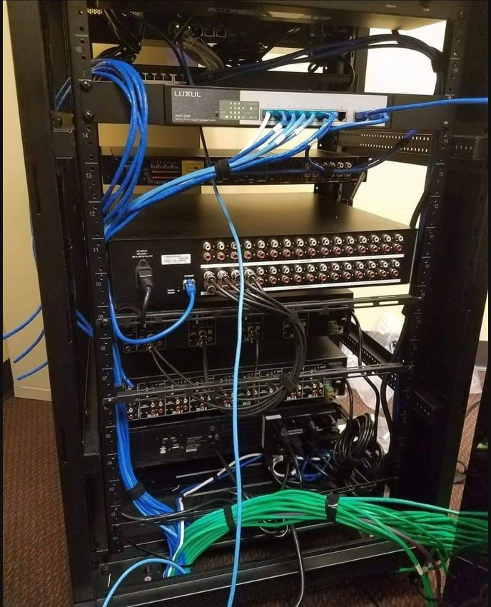 Network rack with patch cabling during AV troubleshooting
