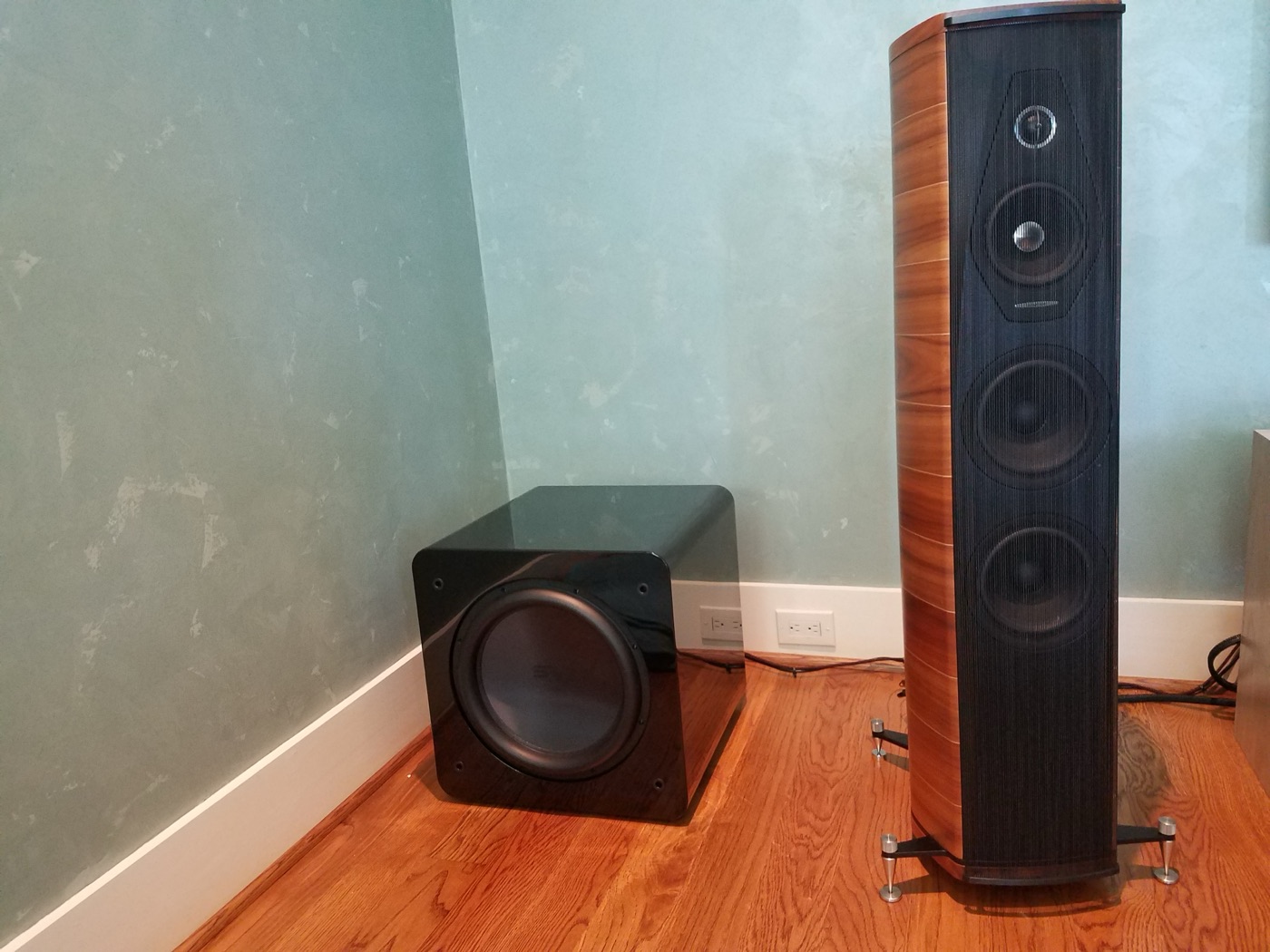 Sonus Faber tower speaker beside a gloss-black subwoofer in a Woodlands home