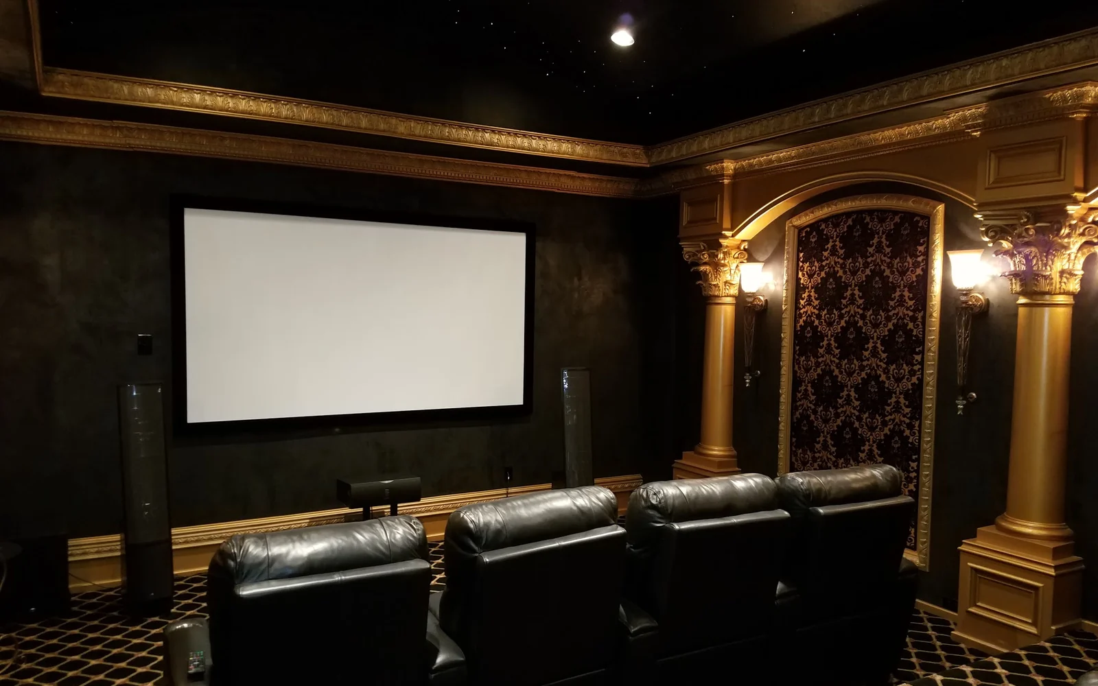 Luxury Houston home theater with projection screen, theater seating, and architectural lighting